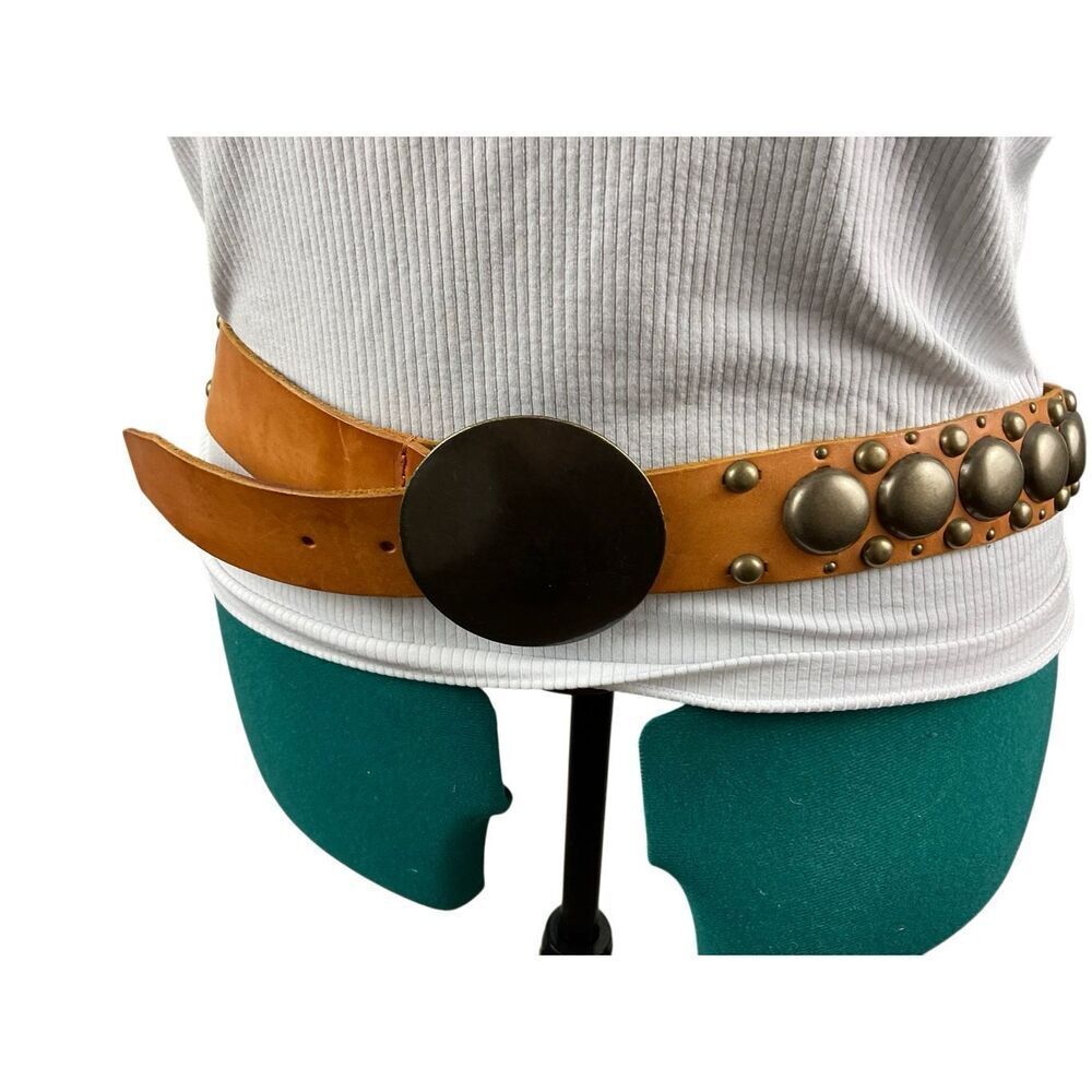 Light brown belt with metal studs and large metal buckle